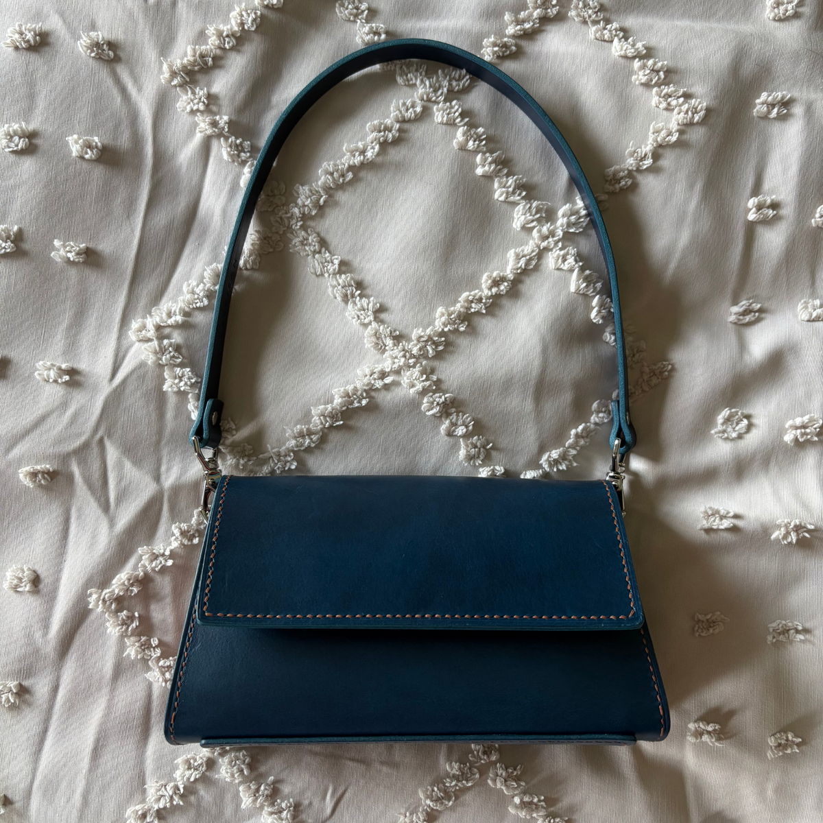 Two-tone blue Icona leather shoulder bag with removable leather strap.