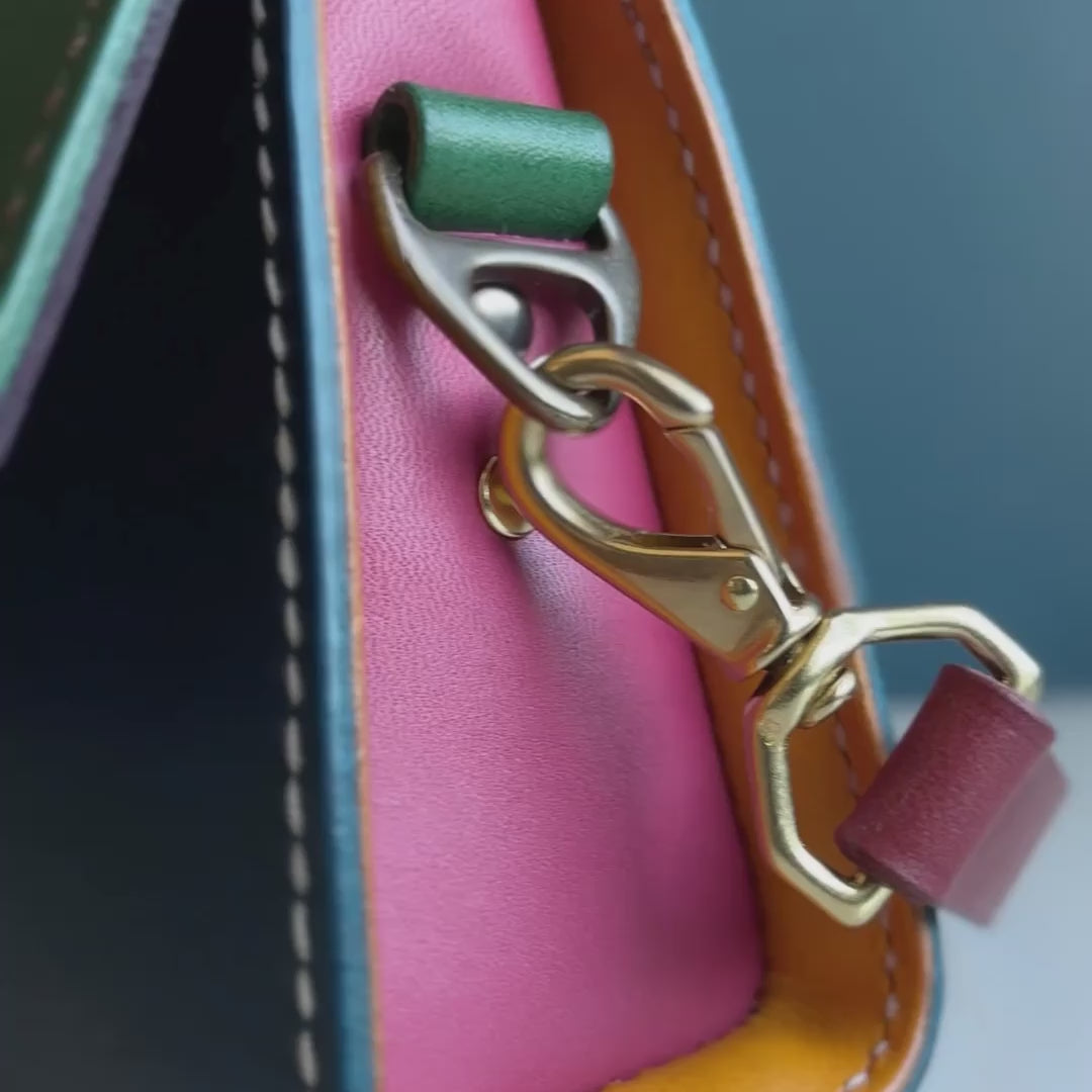 Close-up details of The Wild Card 2026 leather shoulder bag with colorful leather, hand stitching and mixed hardware
